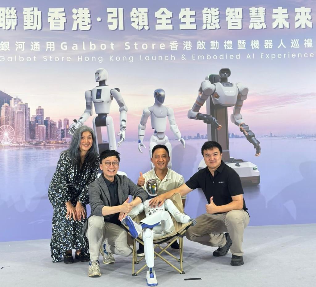 YAS posing with a seated Galbot humanoid at the Galbot Store Hong Kong launch